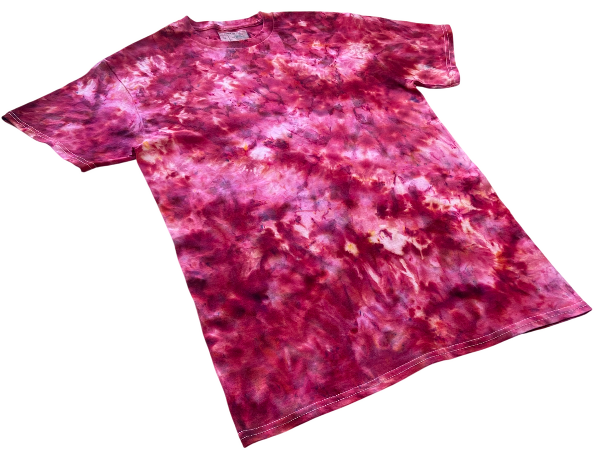 A short-sleeve crewneck t-shirt featuring a vibrant magenta and pink tie-dye pattern with splashes of white and darker purple, displayed flat against a solid white background.