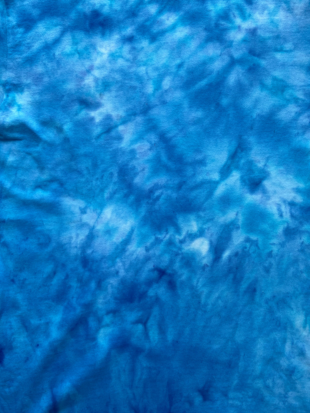 Close-up of Alpine Blue Ice Scrunch tie dye fabric in bright alpine blue, turquoise and white tones, individually hand dyed in the UK.