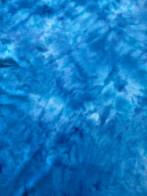 Close-up of Alpine Blue Ice Scrunch tie dye fabric in bright alpine blue, turquoise and white tones, individually hand dyed in the UK.