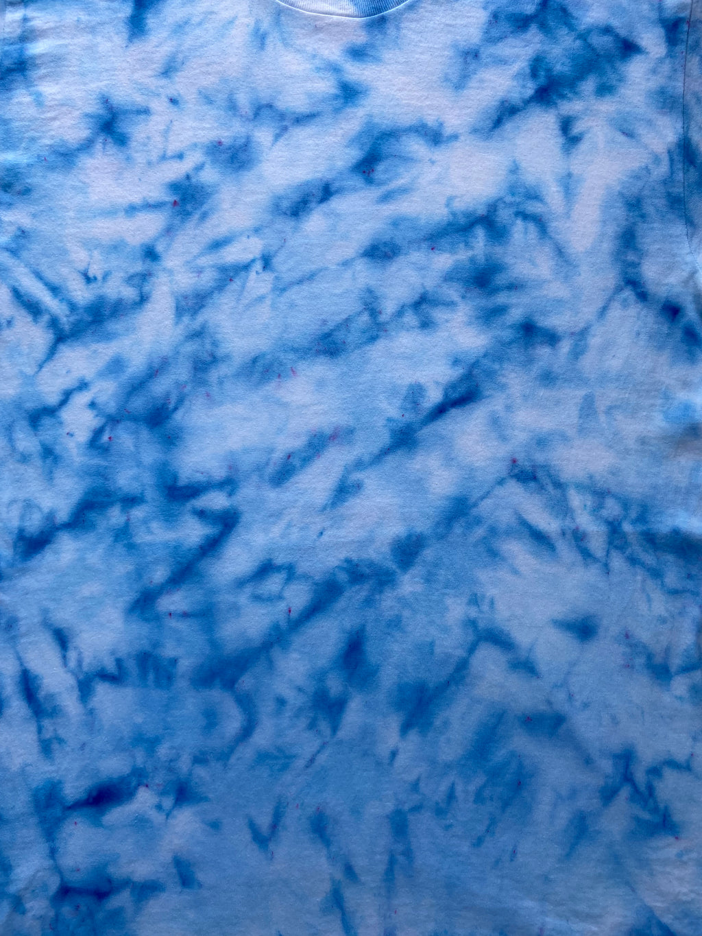 Close-up of Baby Blue Ice Scrunch tie dye fabric in soft sky blue and white tones, individually hand dyed in the UK.