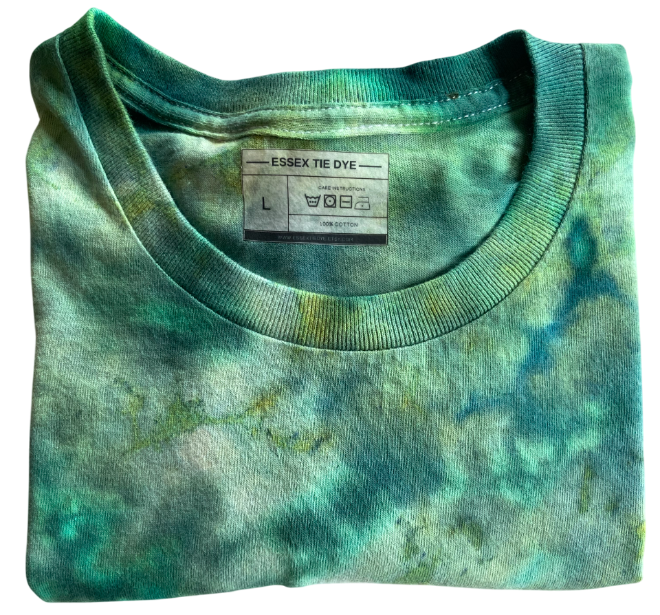 Folded green tie-dye shirt with a label on a white background