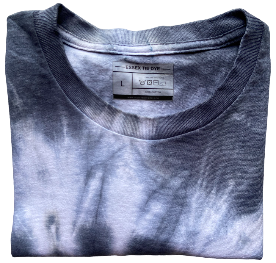 A folded crewneck t-shirt with a black and white tie-dye pattern, featuring the Essex Tie Dye brand label visible inside the collar.