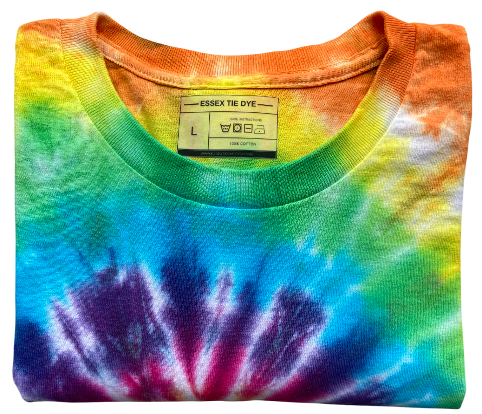 A folded Essex Tie Dye cotton t-shirt featuring a vibrant rainbow spiral tie-dye pattern in blue, purple, green, yellow, and orange, with a ribbed crew neck.