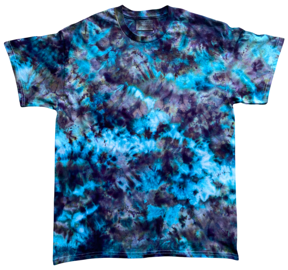 The Alchemist Ice Scrunch tie dye T-shirt featuring vibrant turquoise blue, teal, deep purple and black tones in a striking marbled ice dye pattern.
