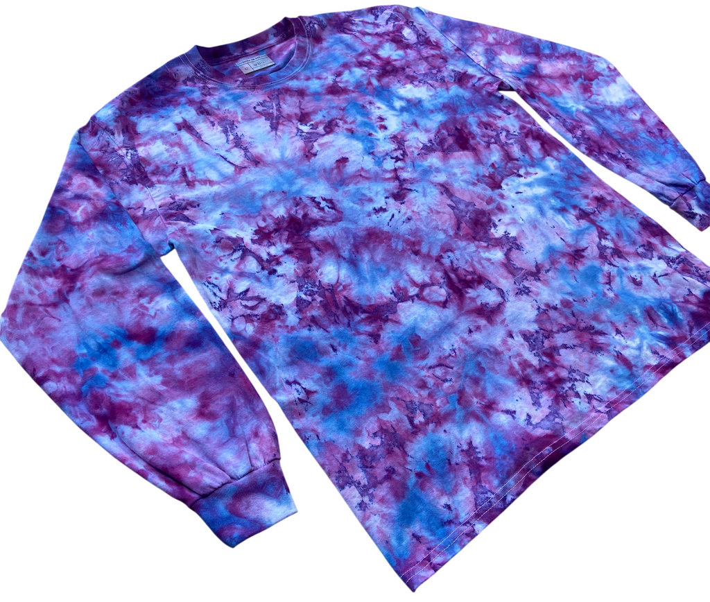 A long-sleeve crewneck shirt with a blue, purple, and white tie-dye pattern, laid flat on a white background.