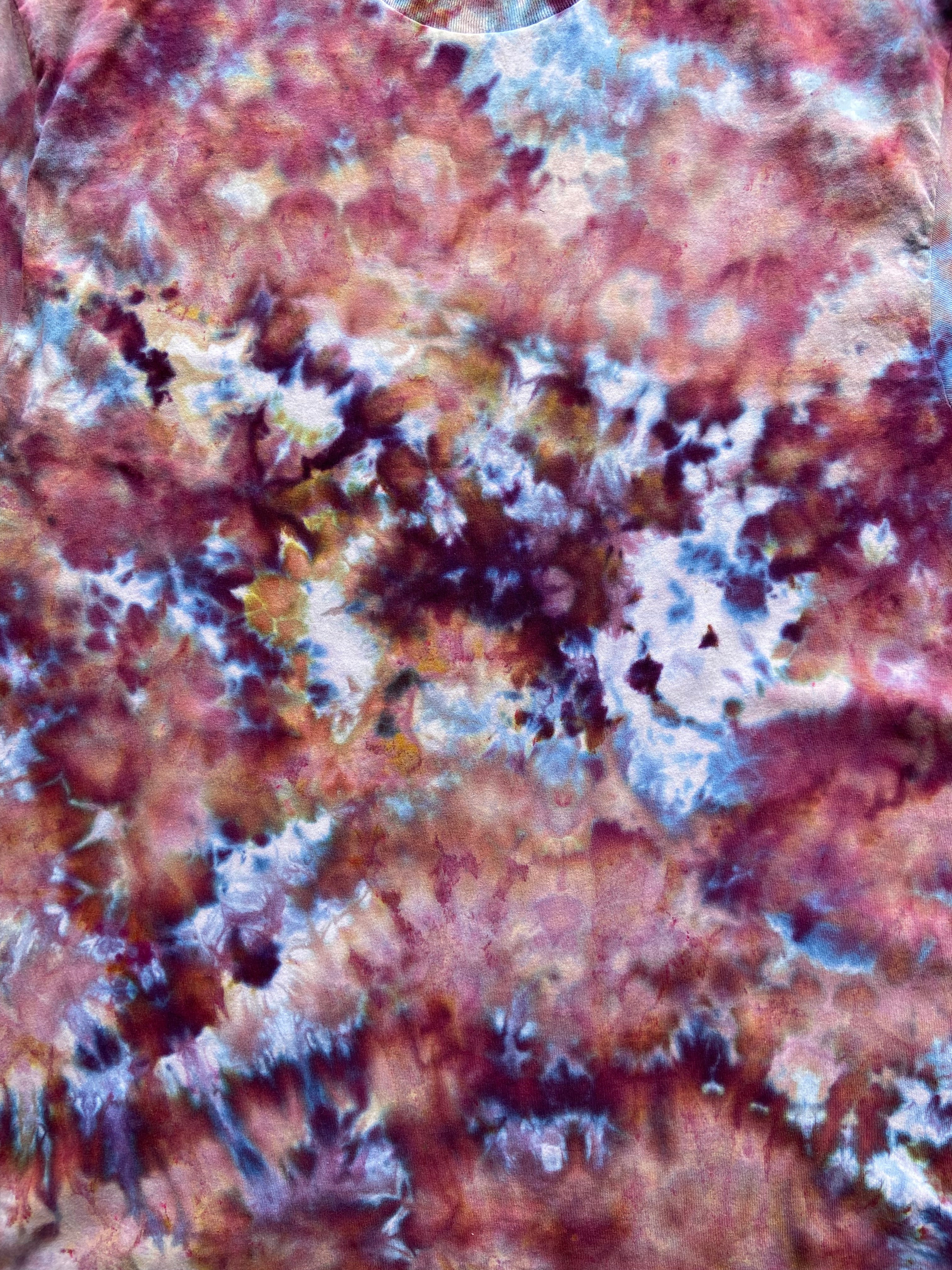 Close-up of a textured surface with red, brown, and white colors