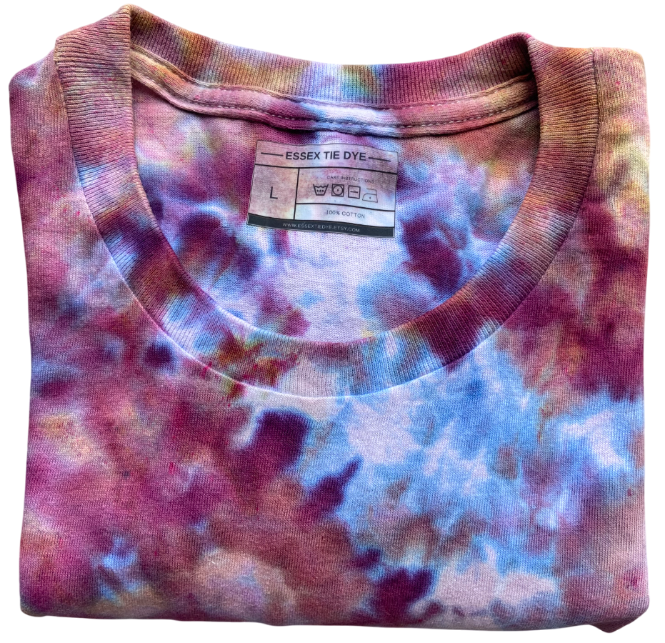 Folded tie-dye shirt with a visible label on a white background