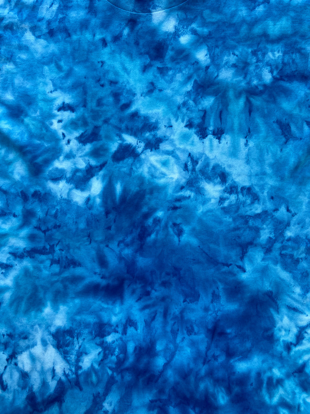 Close-up of Electric Blue Ice Scrunch tie-dye fabric featuring rich electric blue tones with lighter blue mottled detailing.