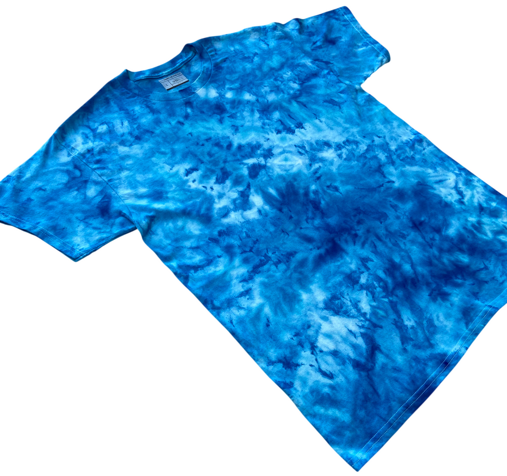 Electric Blue Ice Scrunch tie dye T-shirt shown at an angle, featuring vivid electric blue, turquoise and lighter blue hand-dyed patterns.