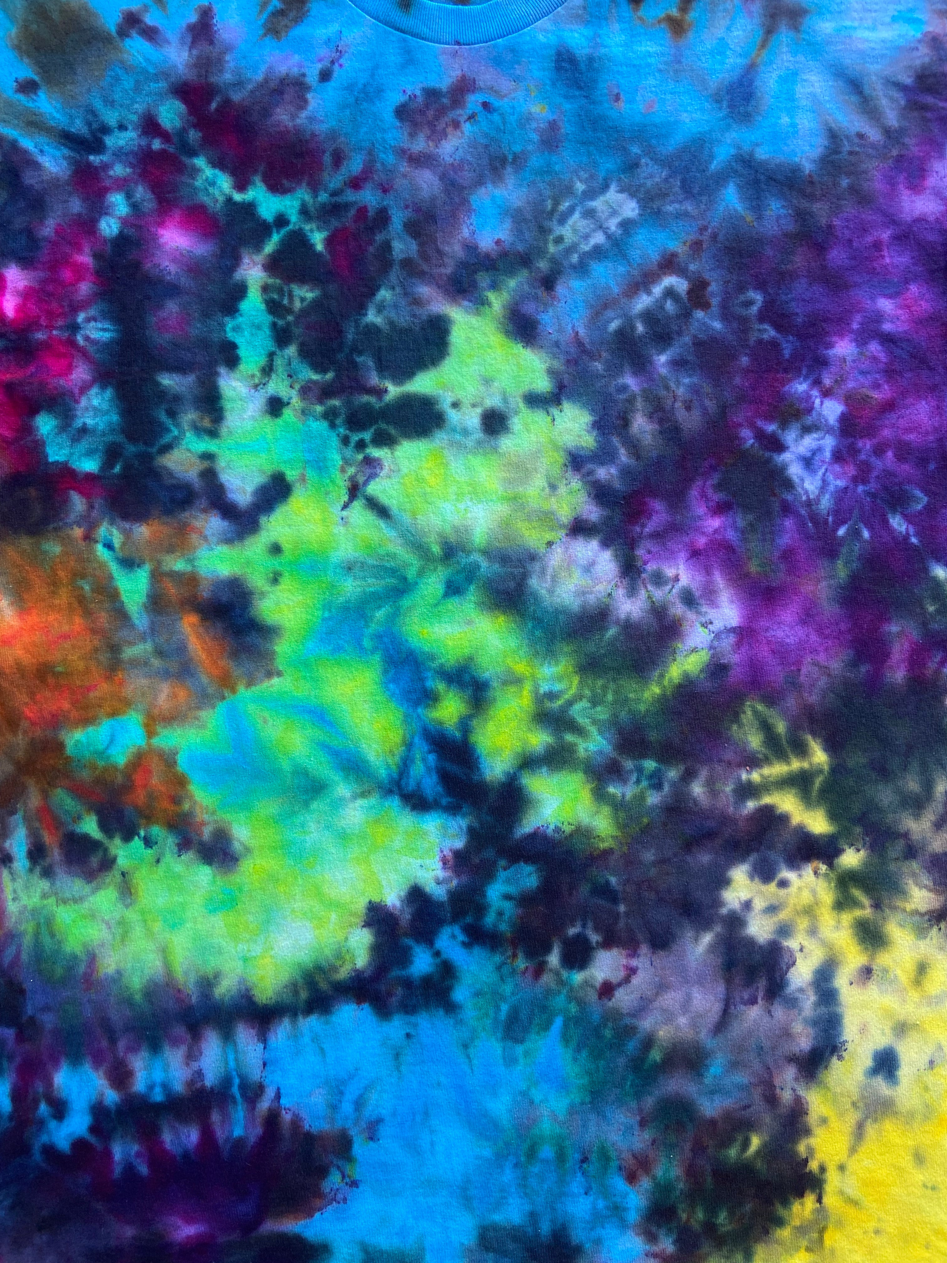 Multicolored tie-dye pattern with a focus on blue, green, and purple.