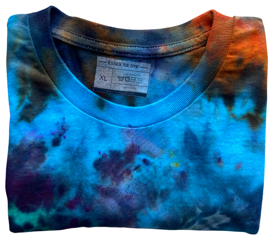 Folded tie-dye shirt with a visible label on a white background
