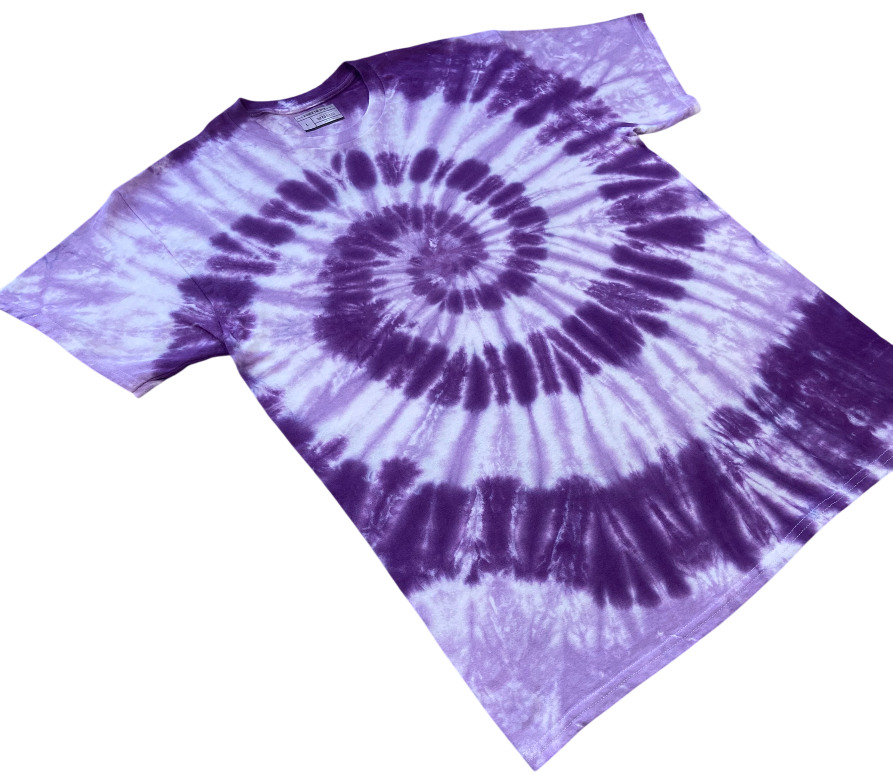 A purple and white spiral tie-dye t-shirt laid flat against a solid white background.