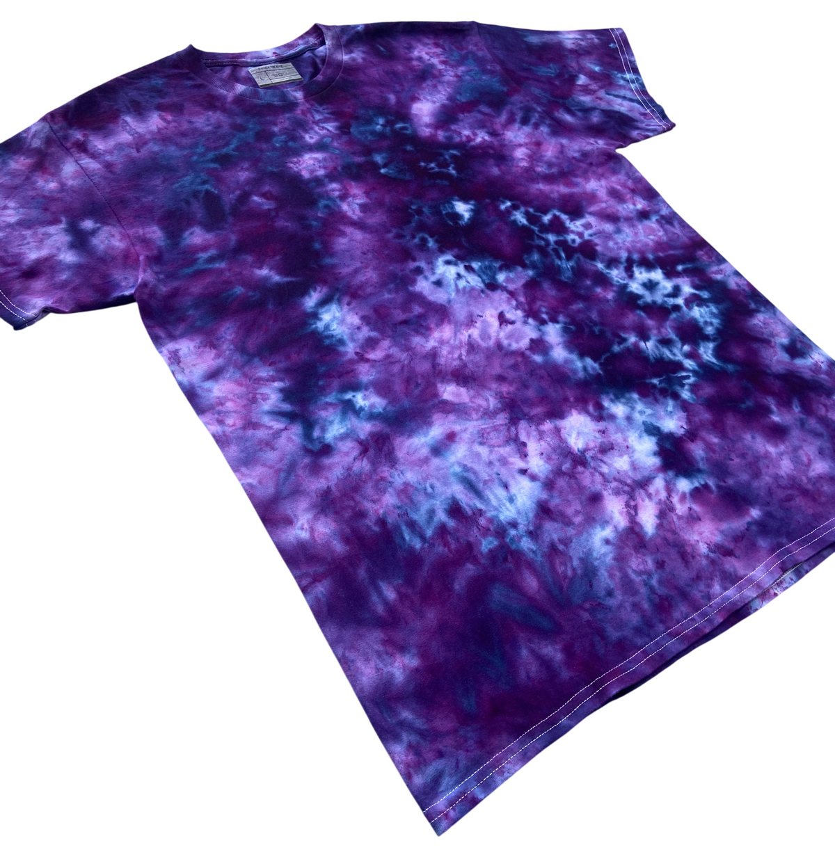 Powerberry tie-dye T-shirt shown at an angle, featuring deep berry-purple and blue tones with lighter cloudy highlights.